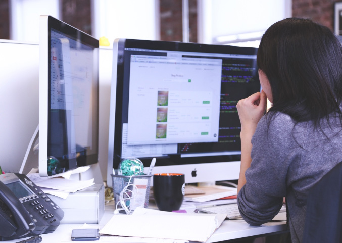 Girl in workplace and office working on her computer at NGX Interactive