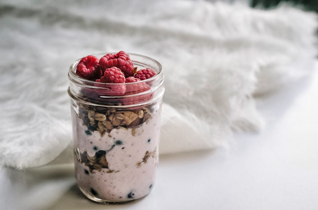yogurt cup with super fruit sundae snack and raspberries