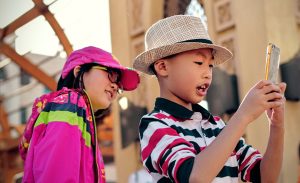 Two kids watching a phone