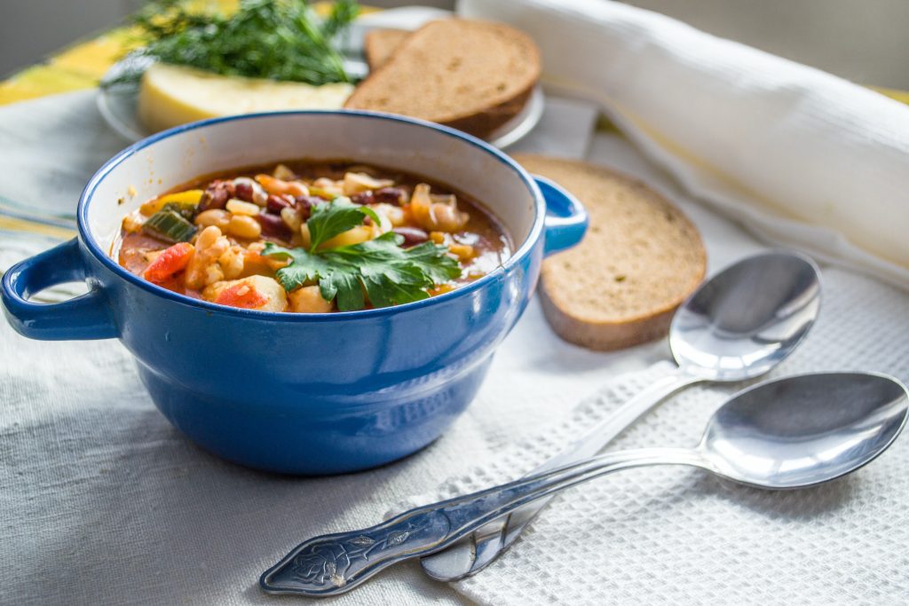 bowl of soup and two silver spoons