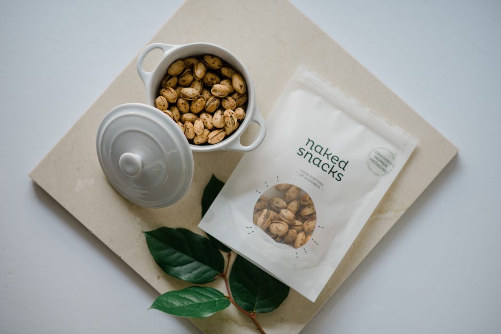 A bag of cracked pepper pistachios snacks from naked snacks
