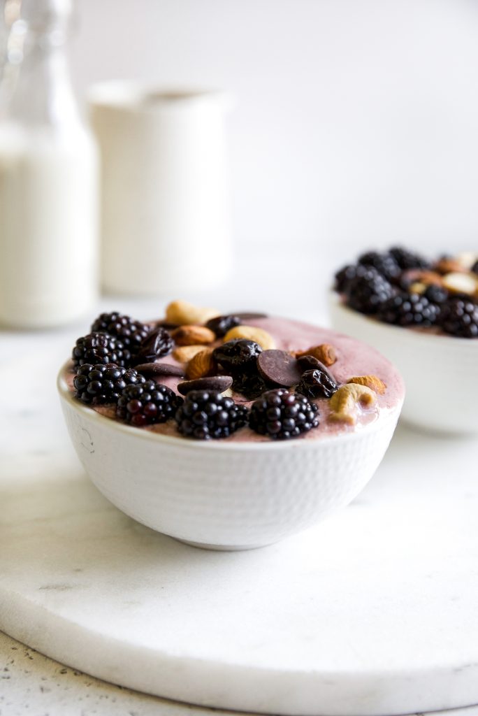 Image of a berry smoothie bowl topped with Tuscan Road Trip, blueberries and nuts