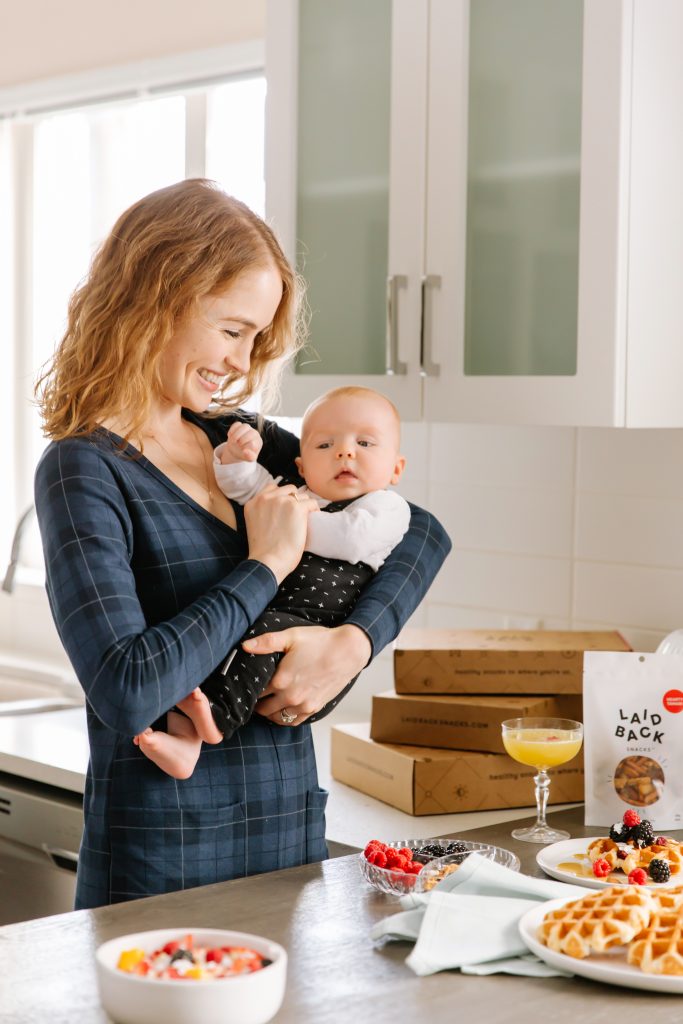 Ryley and baby Henry for Laid Back Snacks' Mother's Day 2021 Gift Box. Woman holding baby.